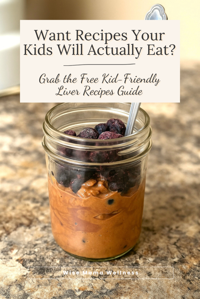 Mason jar of chocolate liver smoothie topped with blueberries and text “Want Recipes Your Kids Will Actually Eat? Grab the Free Kid-Friendly Liver Recipes Guide.”