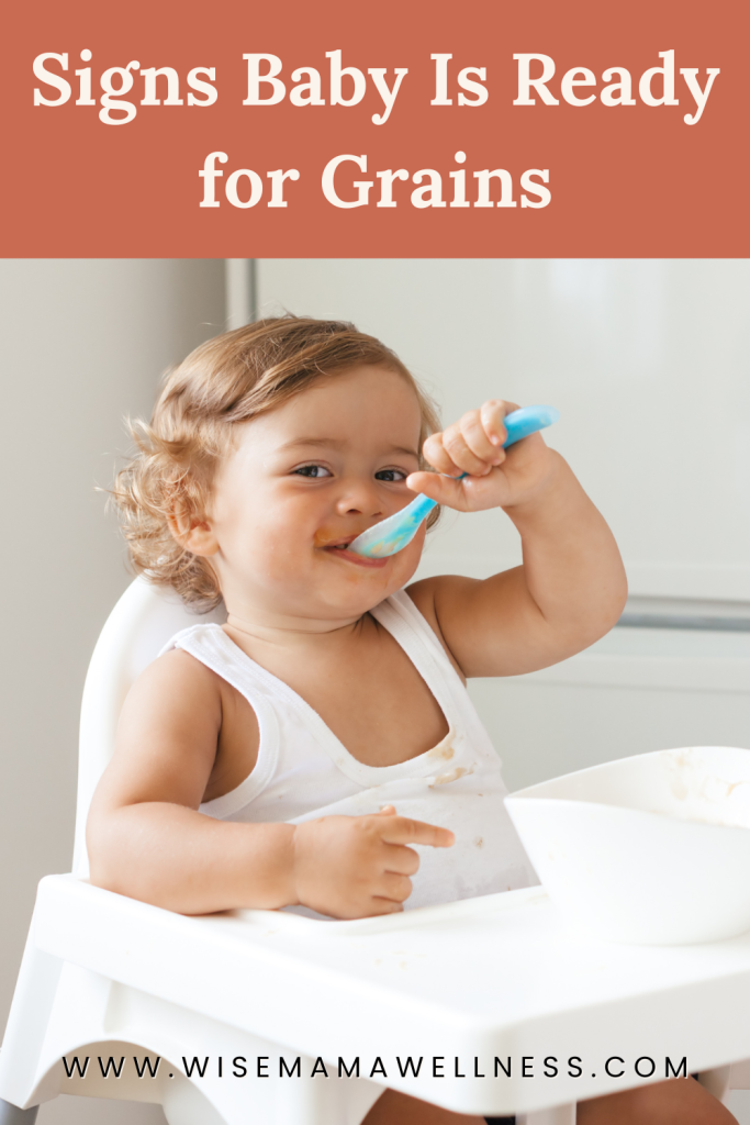 Baby feeding themselves with a spoon, showing signs of readiness for grains