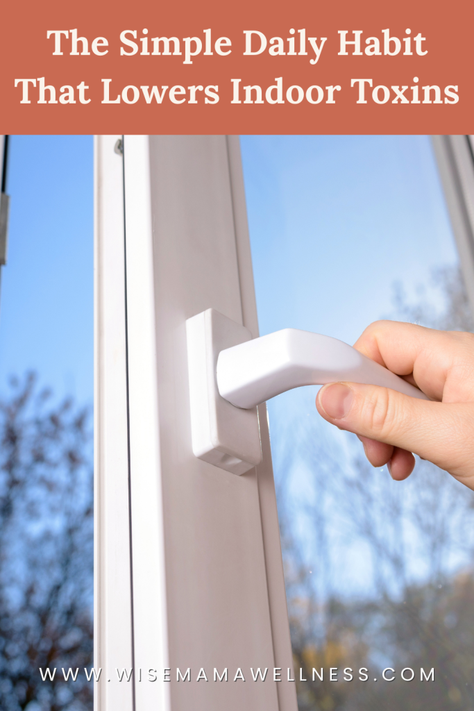 hand opening a window to ventilate a low-toxin home